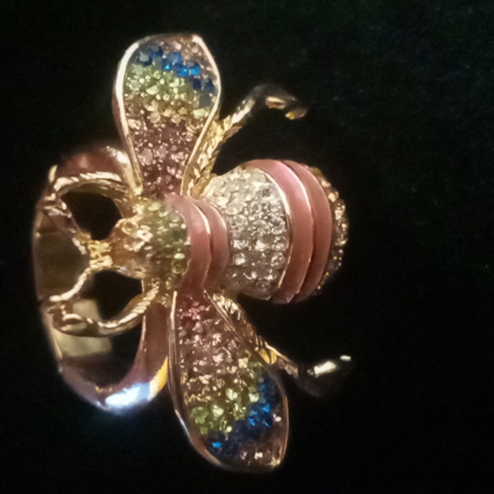 Bee stent ring gold tone expandable with multi color rhinestone wings.